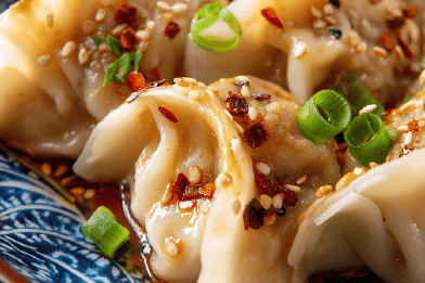 Pork Dumplings with Spicy Peanut Sauce